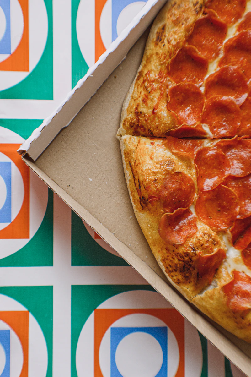 Pizza on a brown cardboard pizza box